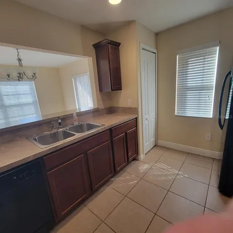 a kitchen with a sink and a mirror