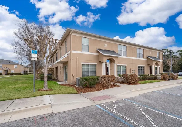 a front view of a building with a garden