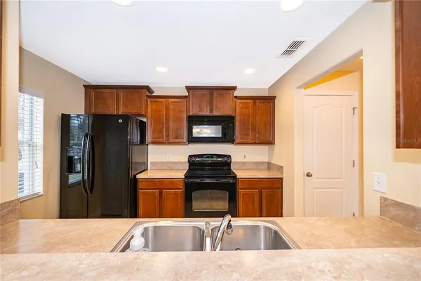 a kitchen with a refrigerator and a stove