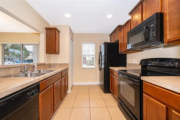 a kitchen with stainless steel appliances a sink stove and refrigerator