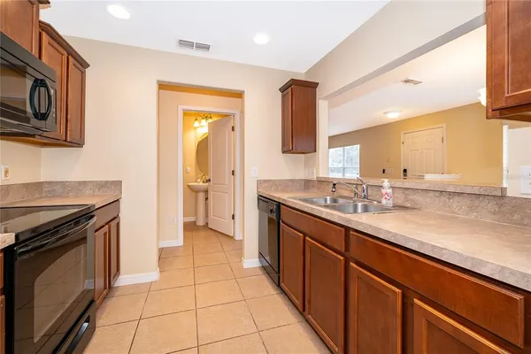 a kitchen with stainless steel appliances granite countertop a sink and a stove