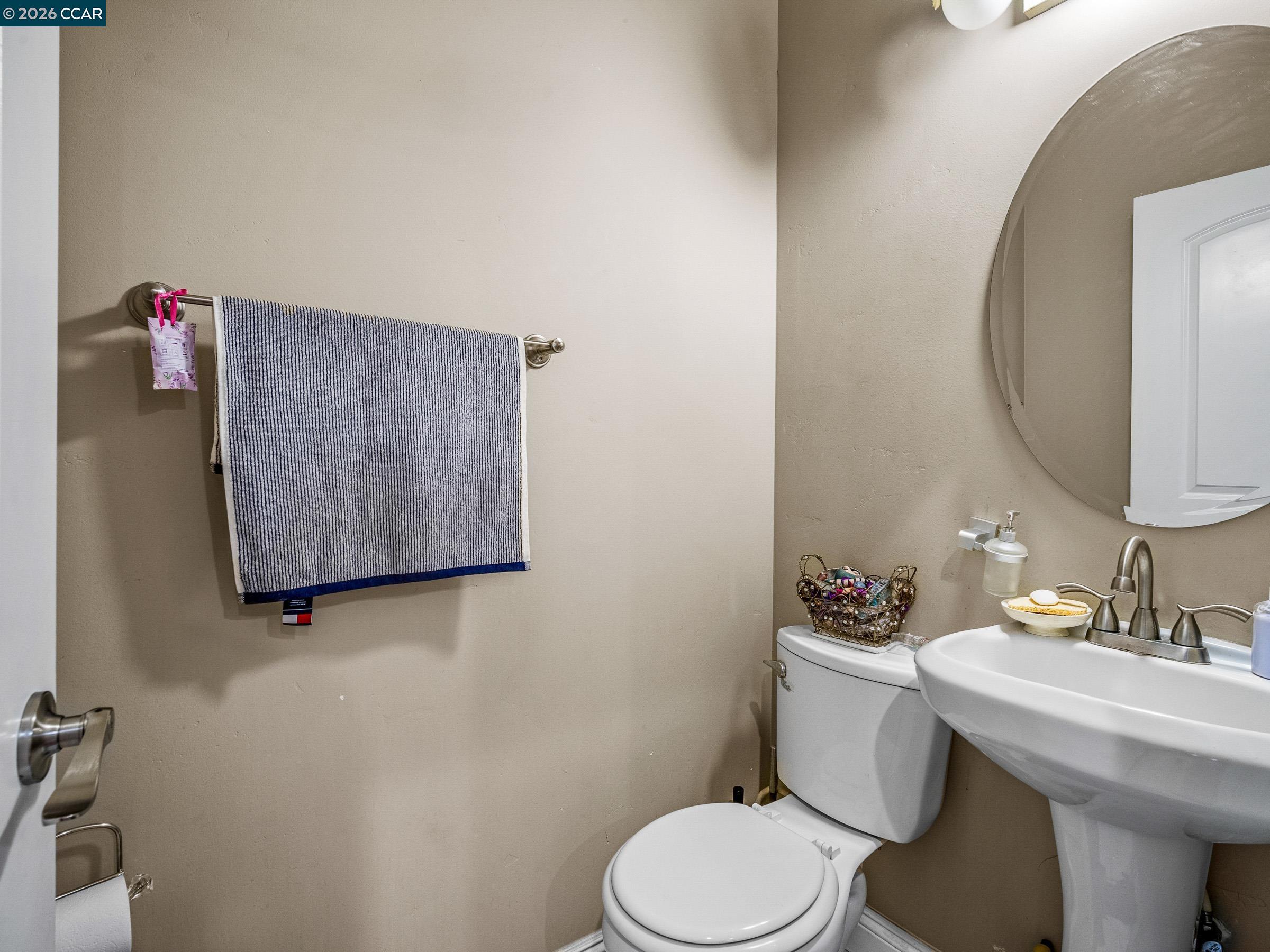 1021 Azusa Street Sacramento, CA 95833 - Photo 21 of 26 a bathroom with a toilet sink and mirror