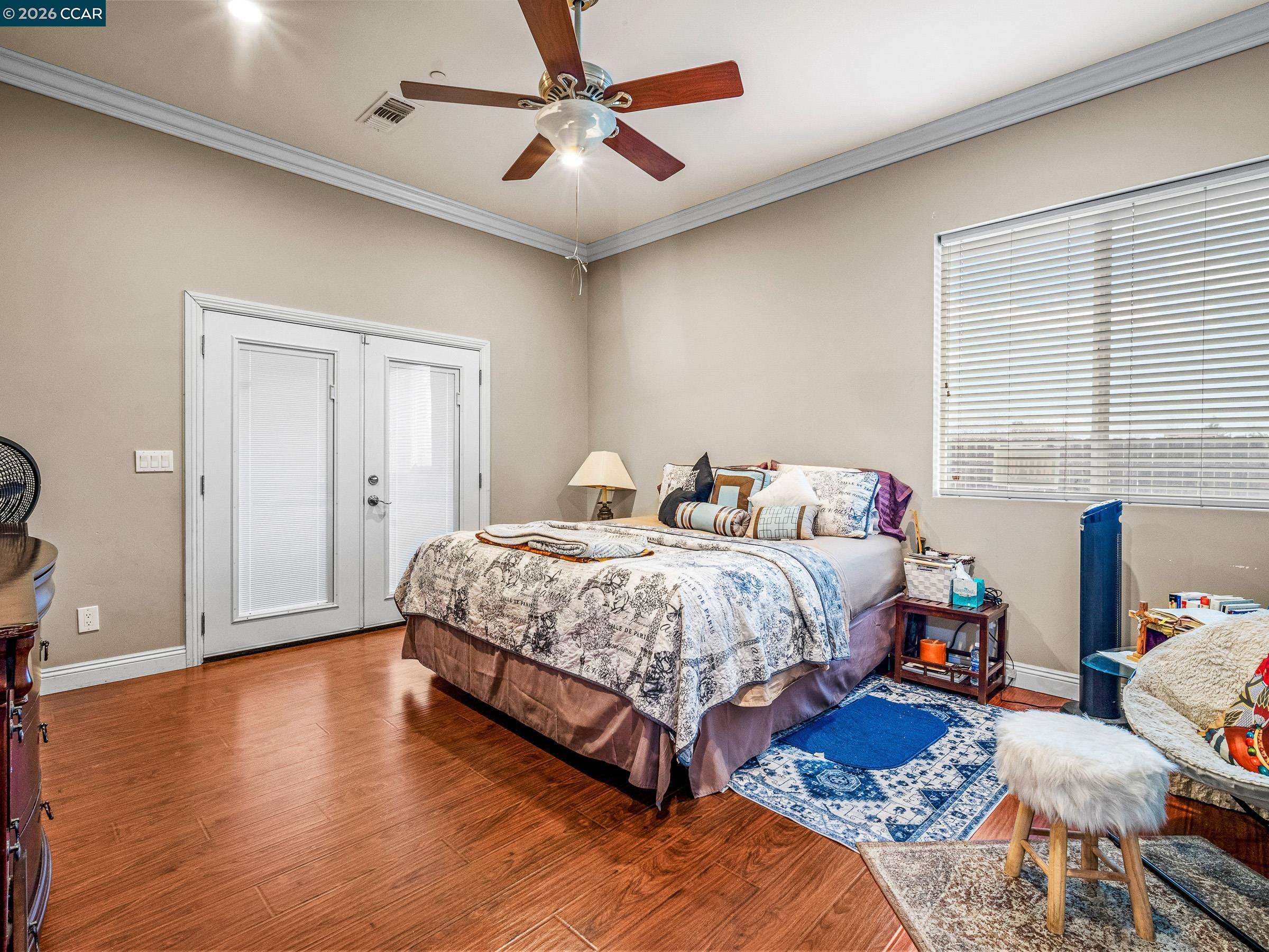 1021 Azusa Street Sacramento, CA 95833 - Photo 22 of 26 a bedroom with a bed and wooden floor