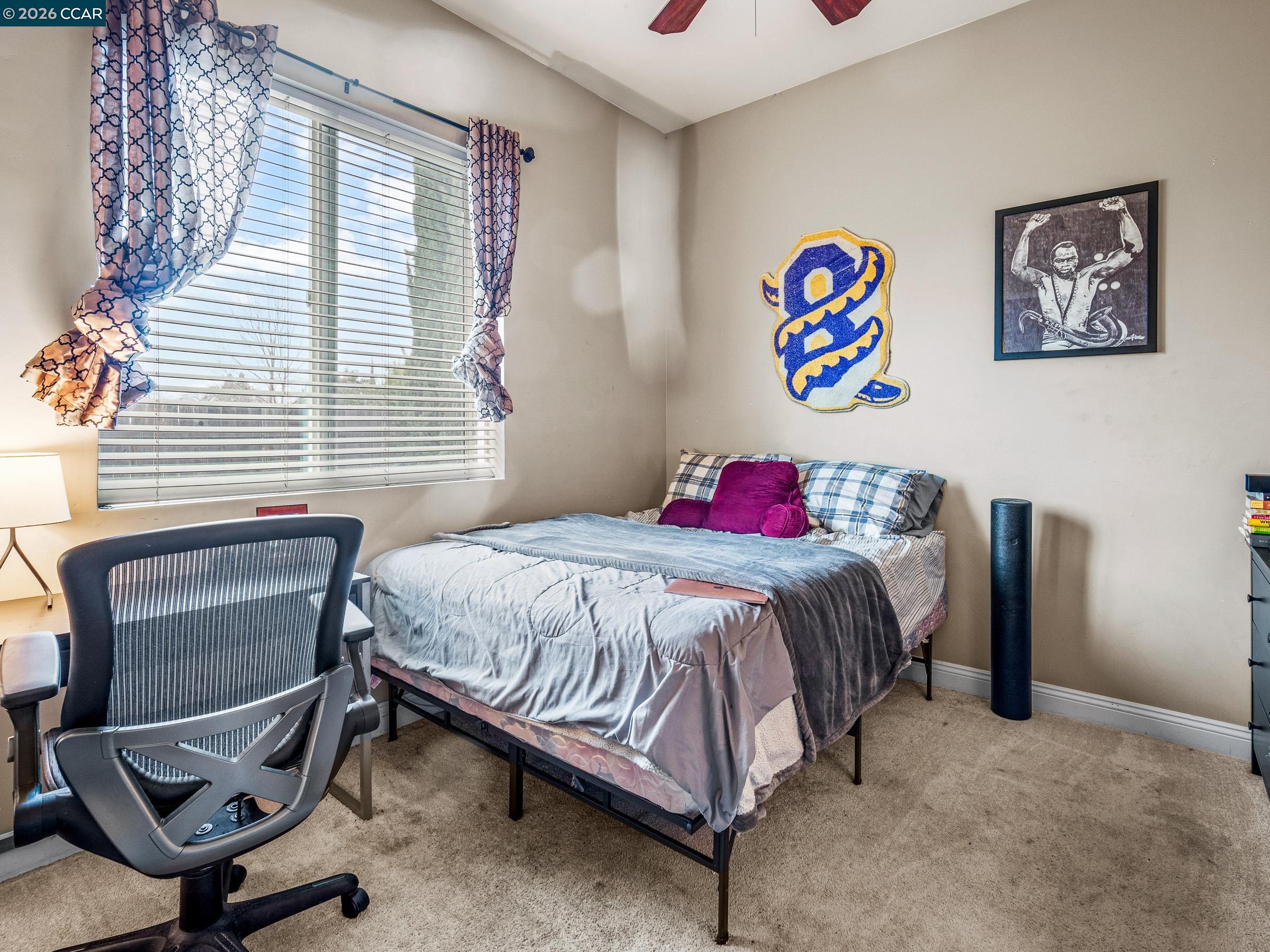 1021 Azusa Street Sacramento, CA 95833 - Photo 24 of 26 a bedroom with a bed and a chair