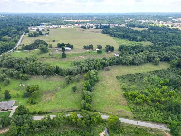 an aerial view of residential houses with outdoor space and river