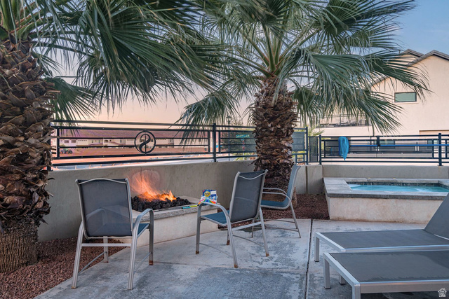 2600 Ocotillo Way, Unit 31 Santa Clara, UT 84765 - Photo 43 of 73 Outdoor patio featuring a built-in fire pit, a hot tub, and two mature palm trees
