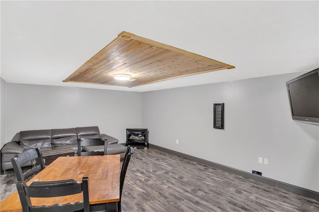391 Bacon Run Road Clarksville, PA 15322 - Photo 21 of 25 Finished lower level is enormous! Plan flooring, decorative wood paneled ceiling, anf neutral colors. Room is complete with cable access.