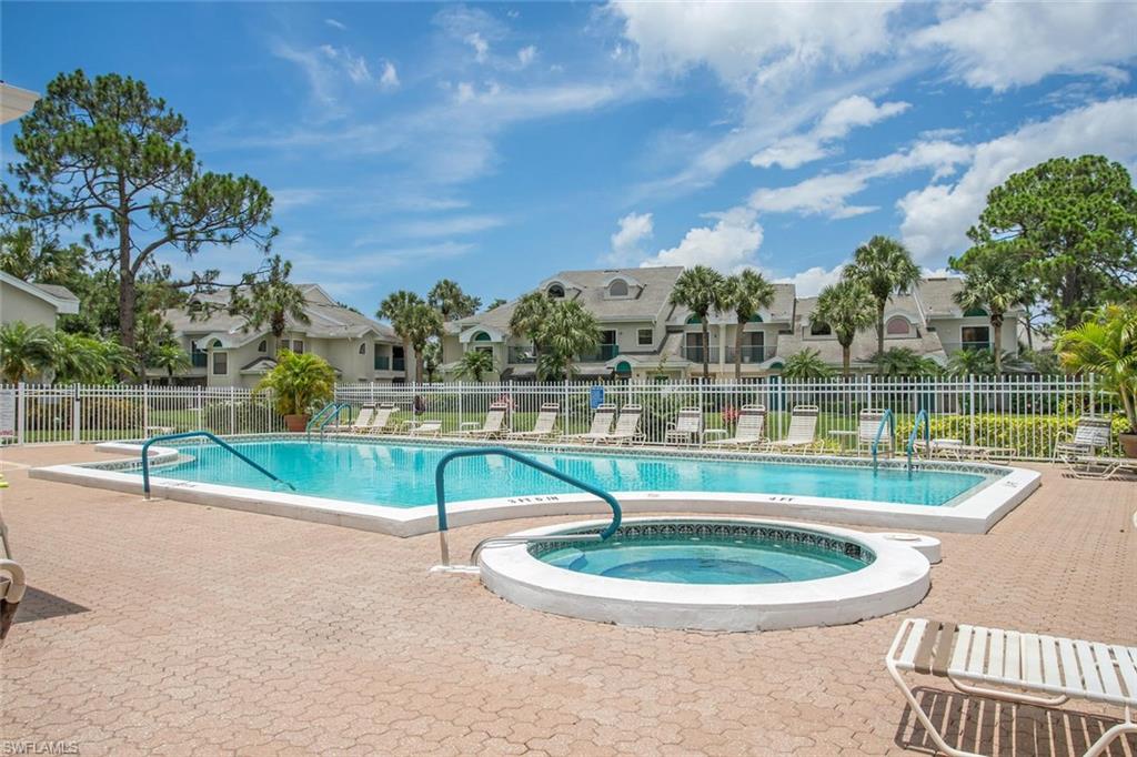 81 Emerald Woods Drive, Unit M8 Naples, FL 34108 - Photo 18 of 18 a view of a swimming pool with a lake
