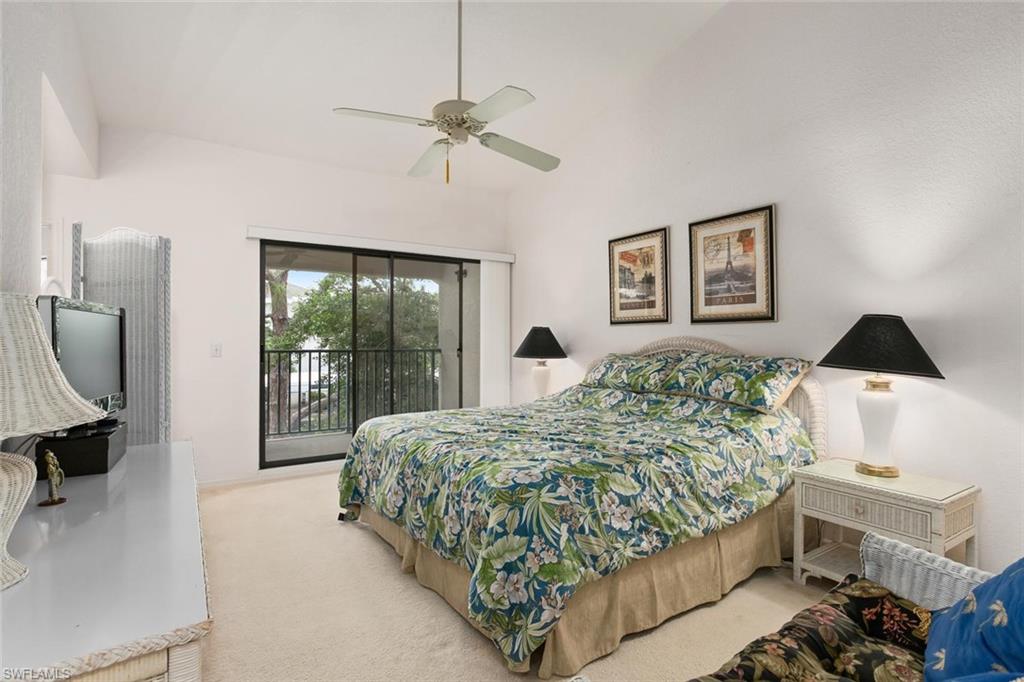 81 Emerald Woods Drive, Unit M8 Naples, FL 34108 - Photo 10 of 18 a living room with a bed furniture and a large window