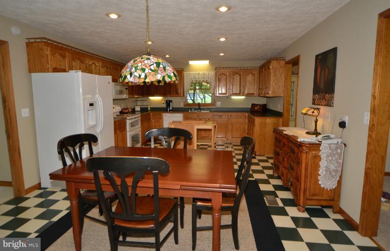 11034 Lucks Road Bumpass, VA 23024 - Photo 13 of 30 The table-space kitchen opens to the sunroom.
