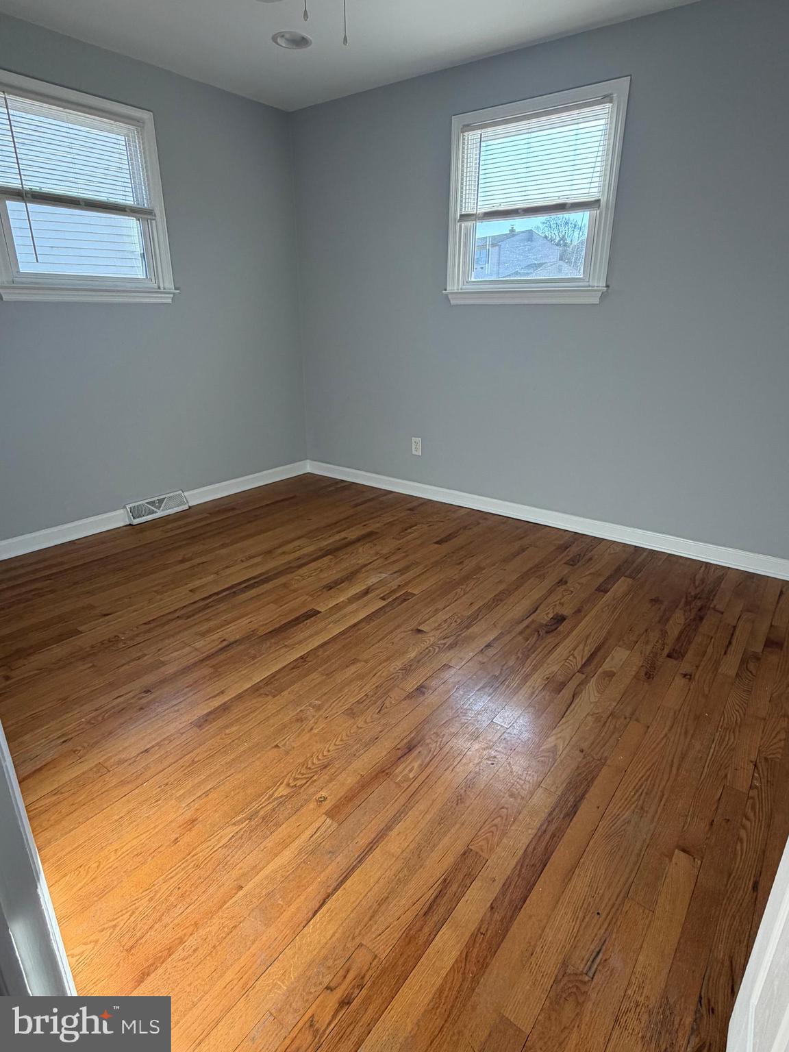 2630 Millcreek Road Wilmington, DE 19808 - Photo 16 of 26 an empty room with wooden floor and windows