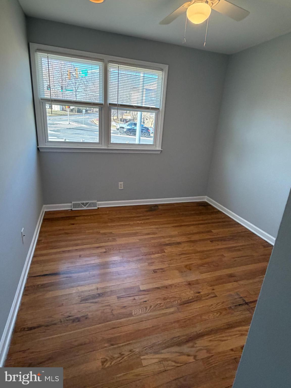 2630 Millcreek Road Wilmington, DE 19808 - Photo 10 of 26 an empty room with wooden floor and windows