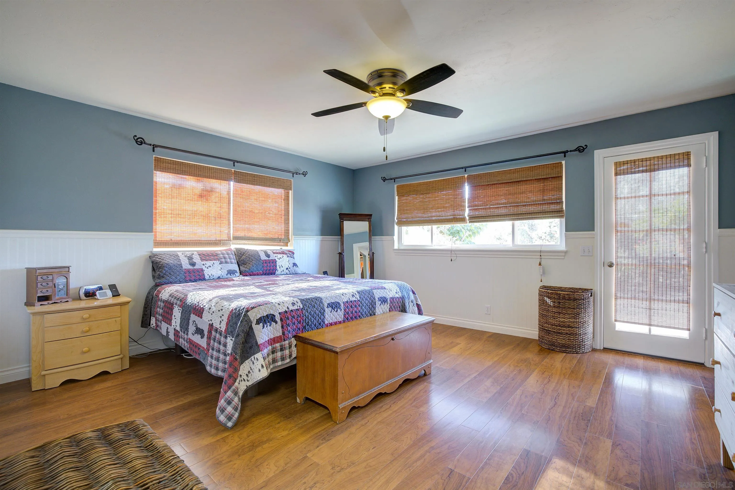 15835 Mactan Road Valley Center, CA 92082 - Photo 14 of 31 a bedroom with a bed and wooden floor