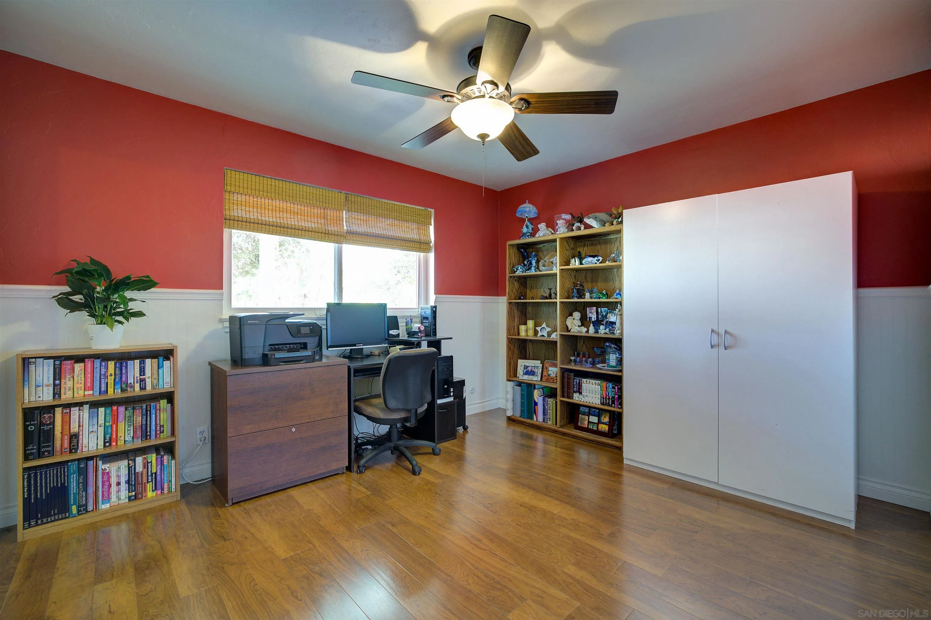 15835 Mactan Road Valley Center, CA 92082 - Photo 18 of 31 a view of a workspace with furniture and a bookshelf