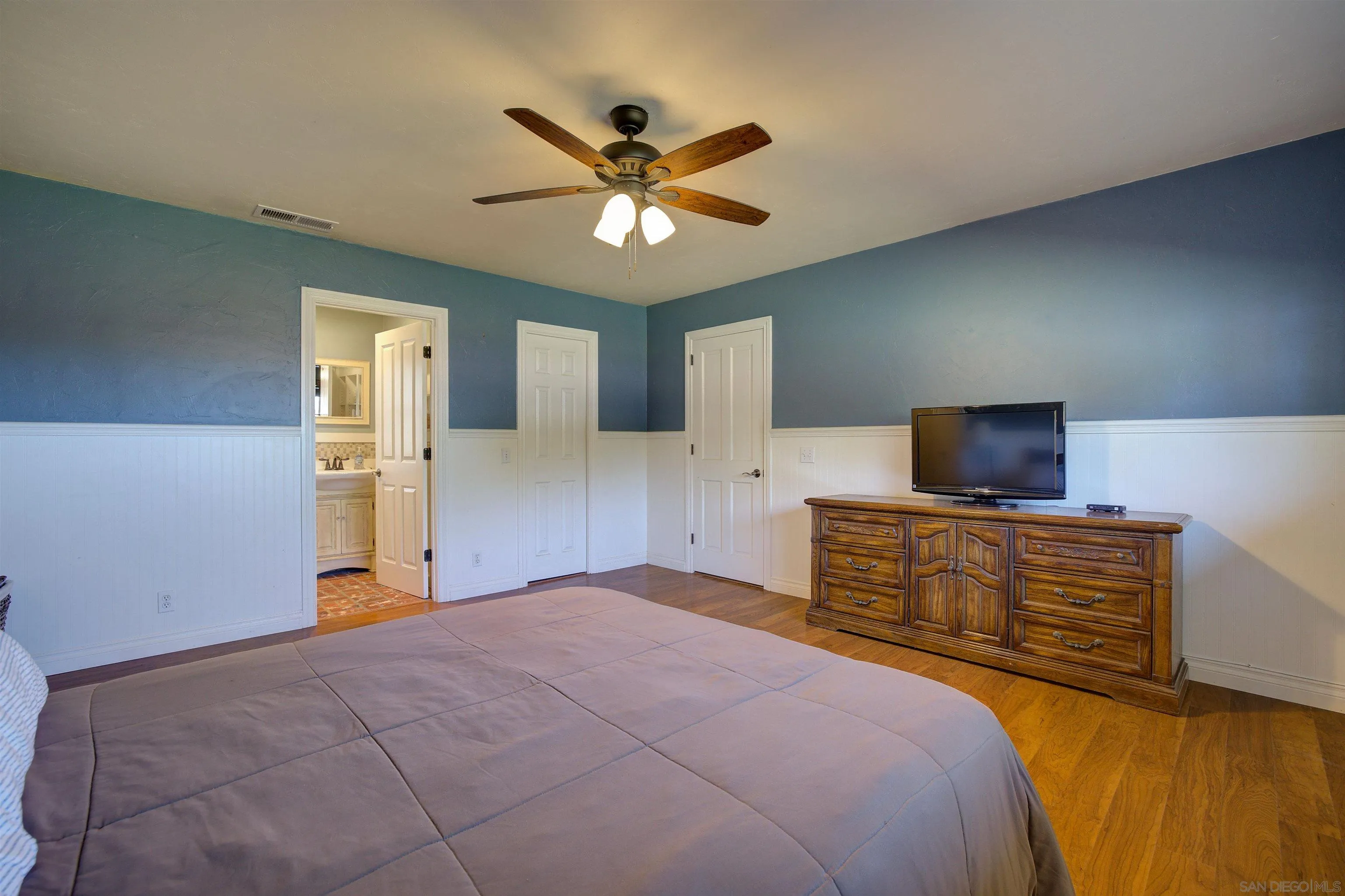 15835 Mactan Road Valley Center, CA 92082 - Photo 20 of 31 a bedroom with a bed and a flat screen tv