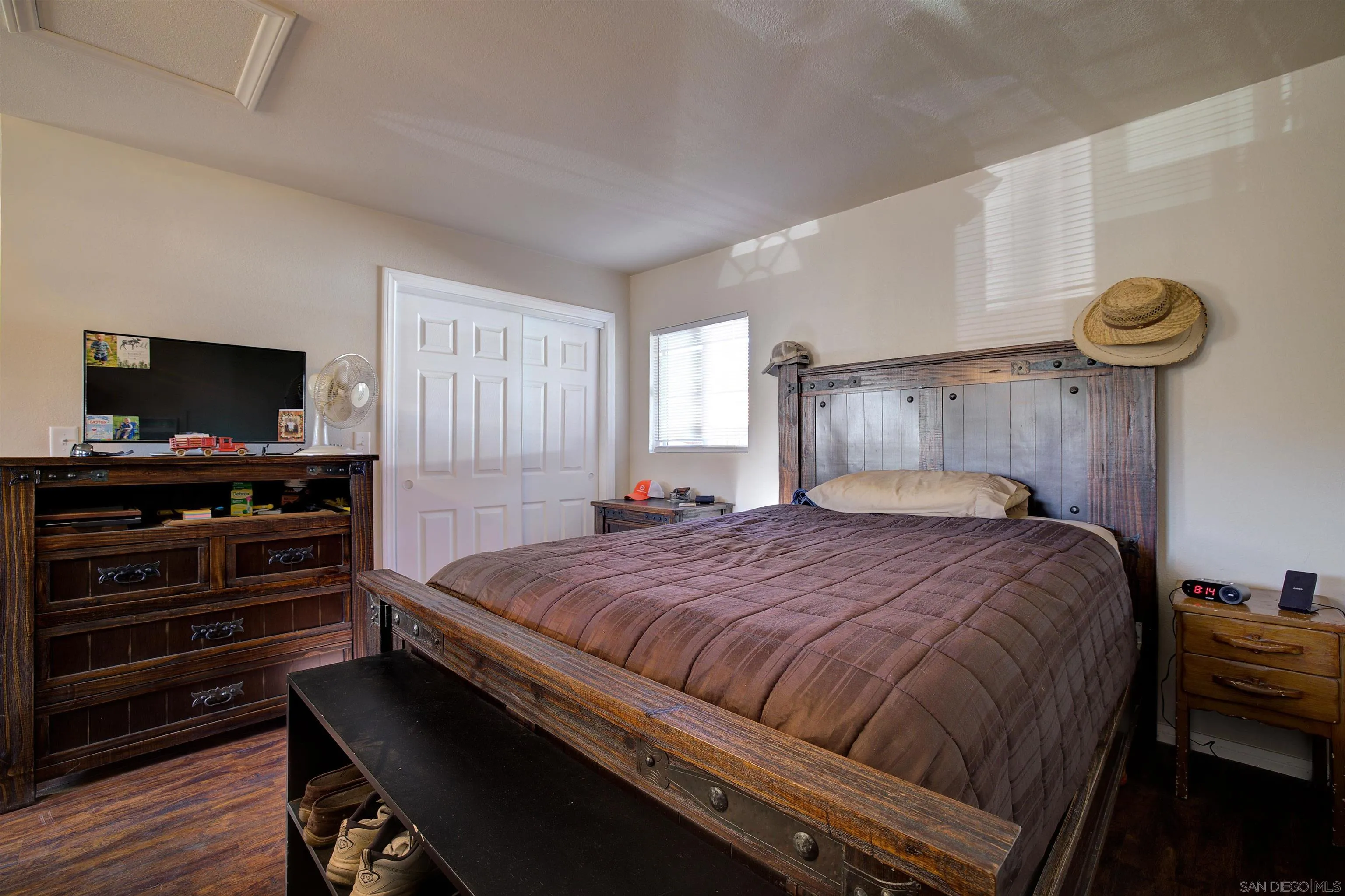 15835 Mactan Road Valley Center, CA 92082 - Photo 26 of 31 a bedroom with a bed and a flat screen tv