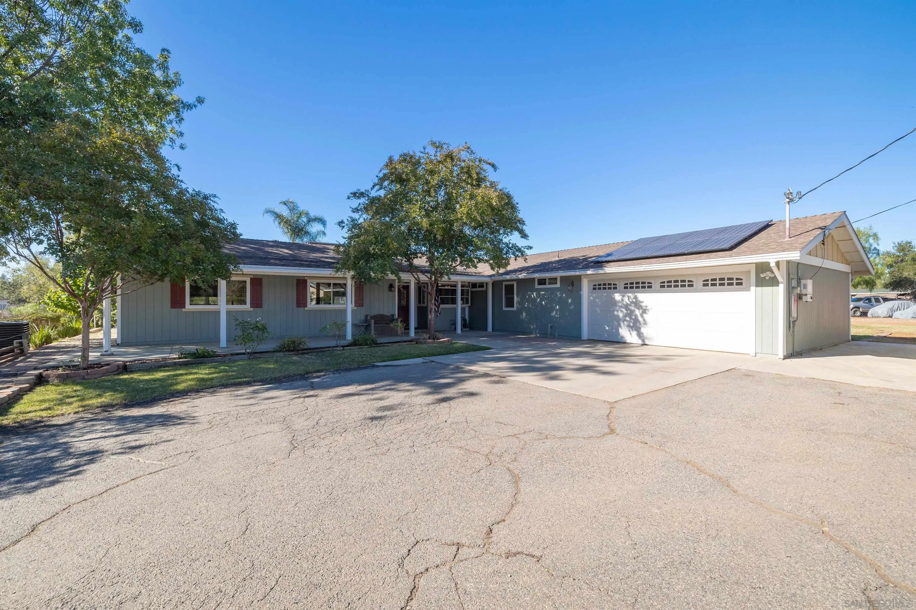 15835 Mactan Road Valley Center, CA 92082 - Photo 4 of 31 a front view of a house with a yard and a garage