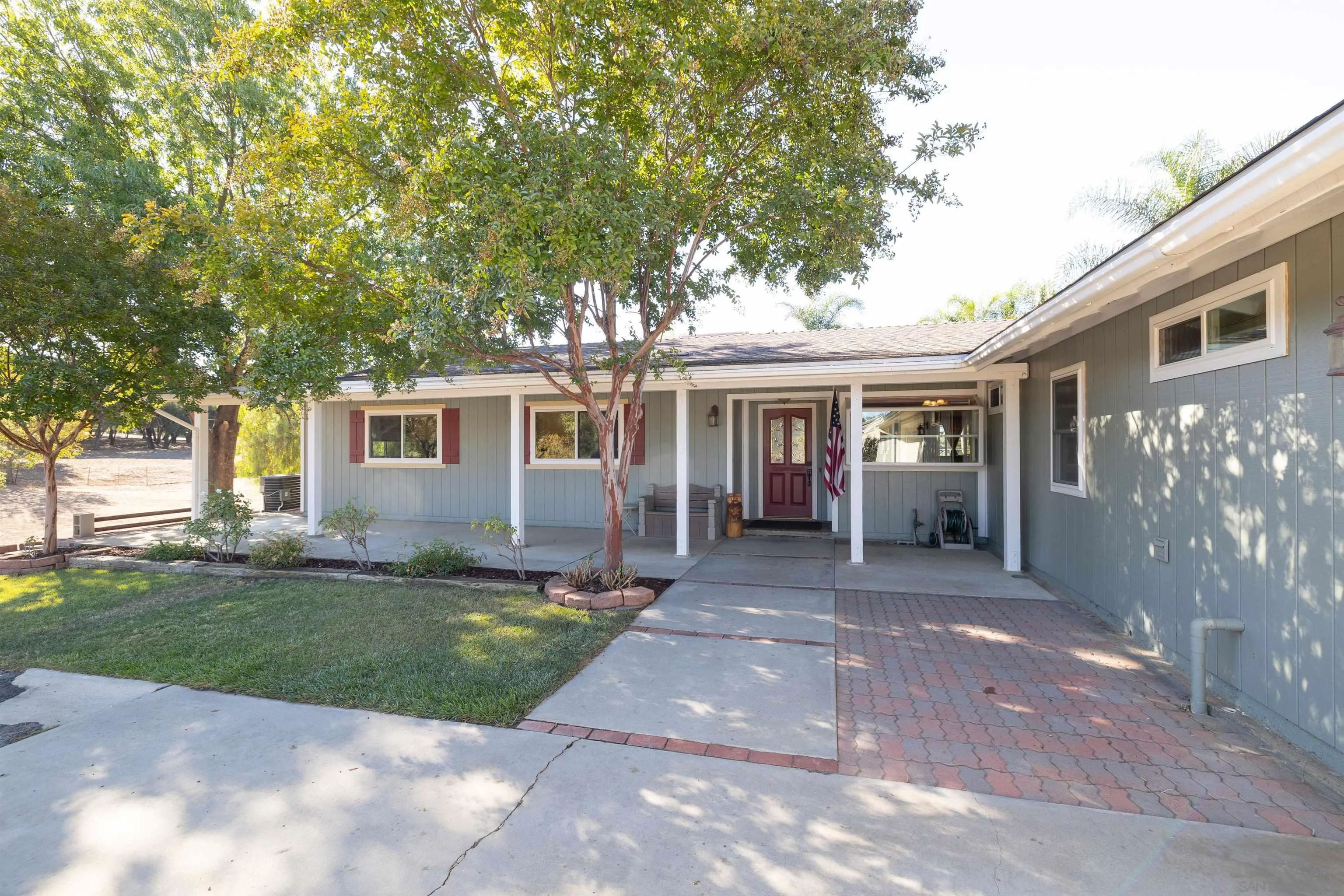 15835 Mactan Road Valley Center, CA 92082 - Photo 5 of 31 a front view of a house with a garden