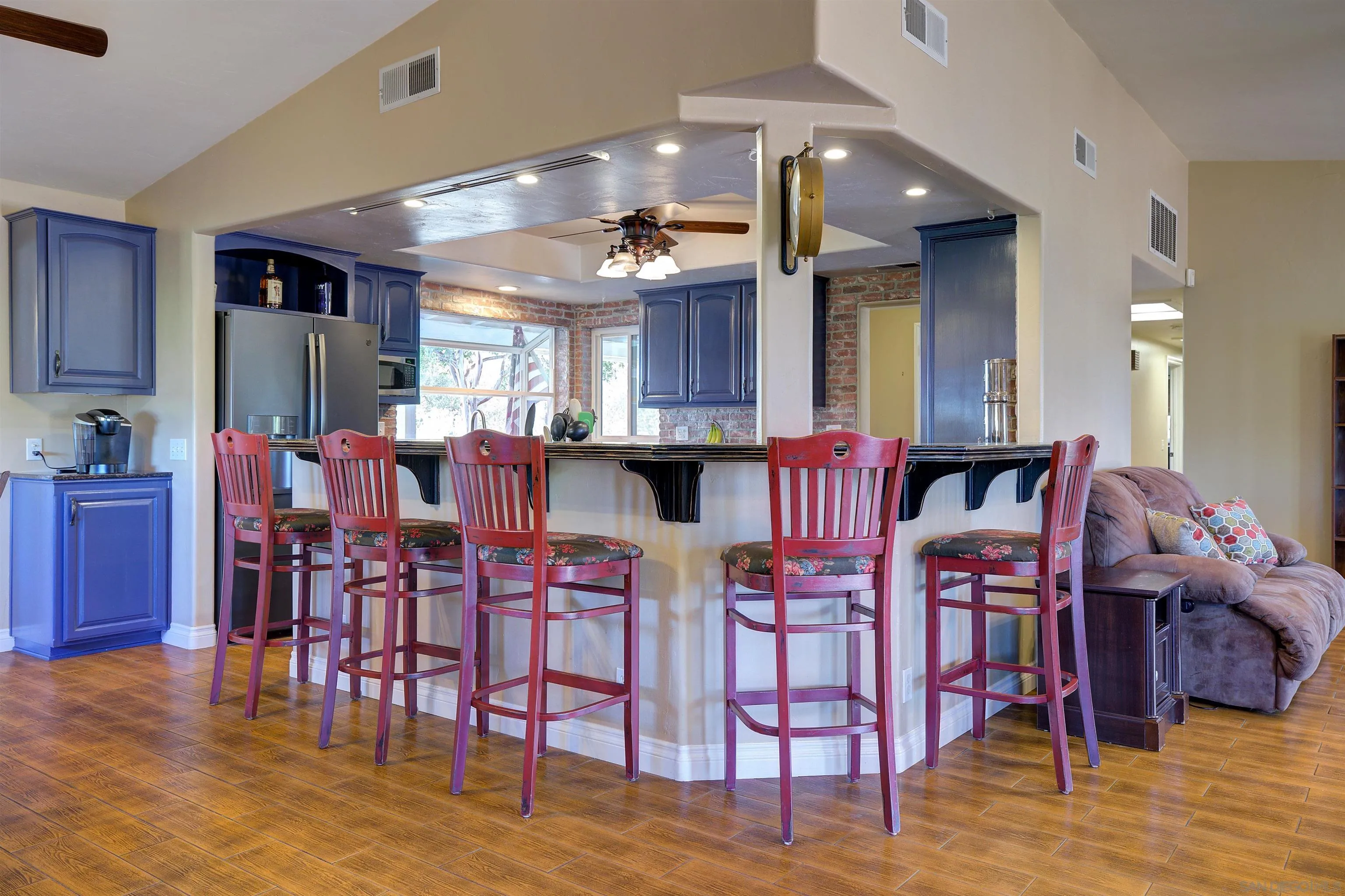 15835 Mactan Road Valley Center, CA 92082 - Photo 9 of 31 a kitchen with stainless steel appliances kitchen island granite countertop a dining table chairs and granite counter tops