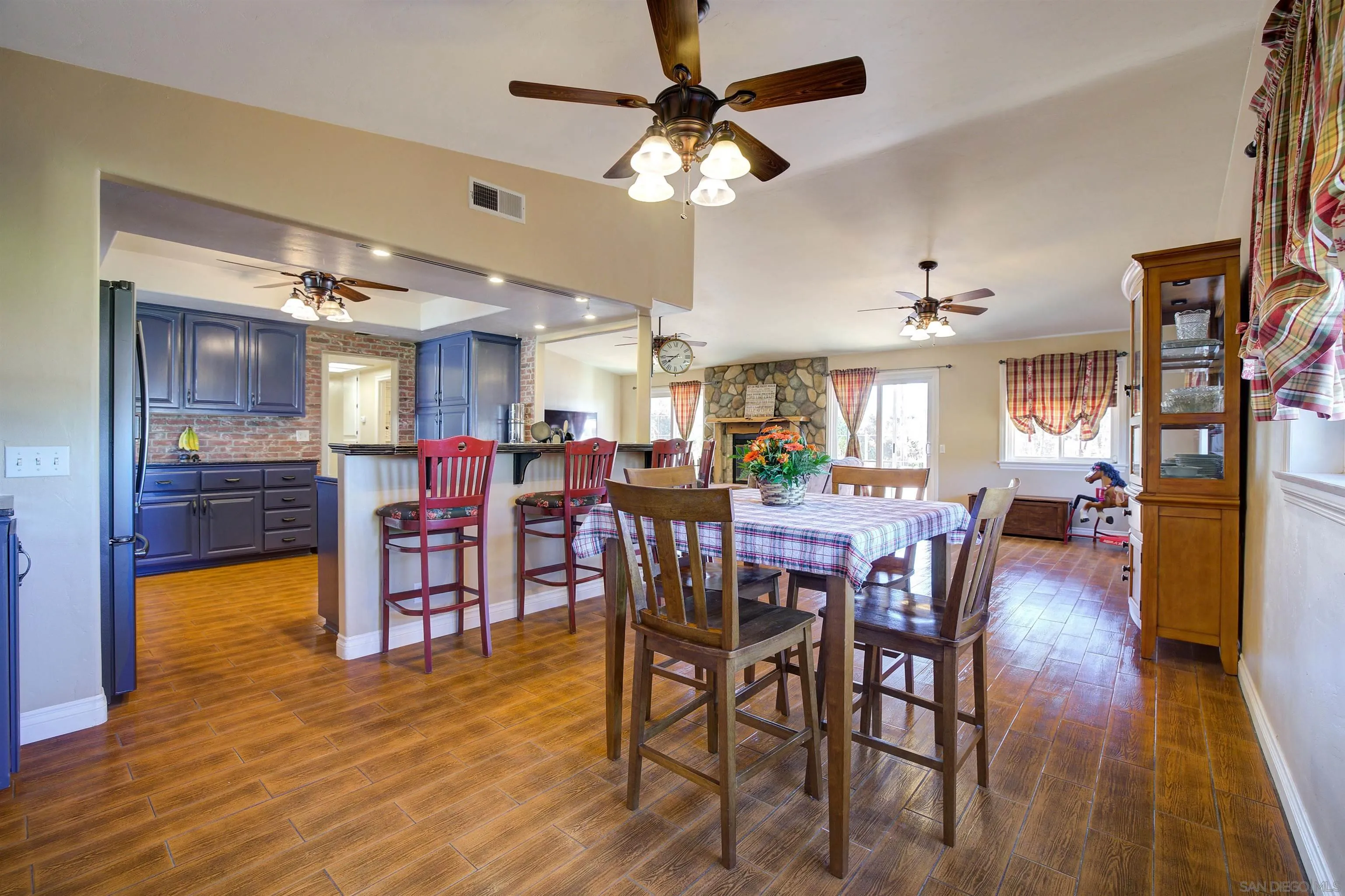 15835 Mactan Road Valley Center, CA 92082 - Photo 10 of 31 a view of a dining area with furniture and wooden floor