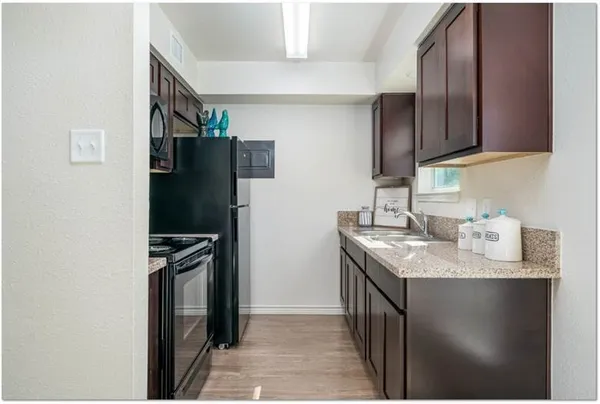 a bathroom with a granite countertop toilet and a shower