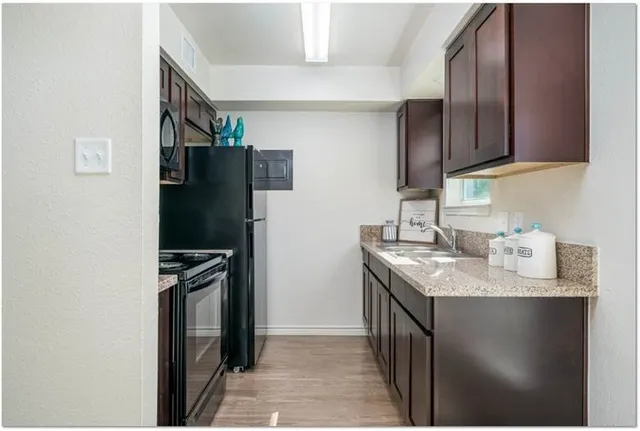 a bathroom with a granite countertop toilet and a shower