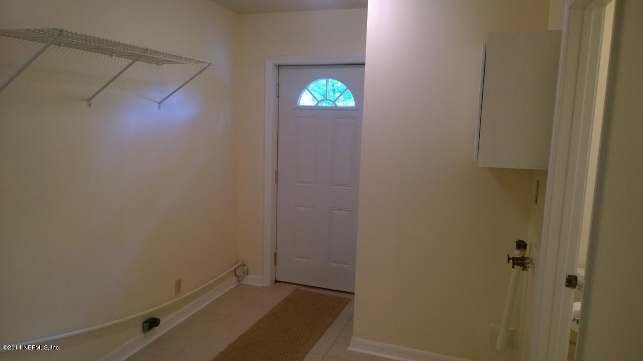13506 Yellow Bluff Road Jacksonville, FL 32226 - Photo 11 of 24 an empty room with walk in closet and wooden floor