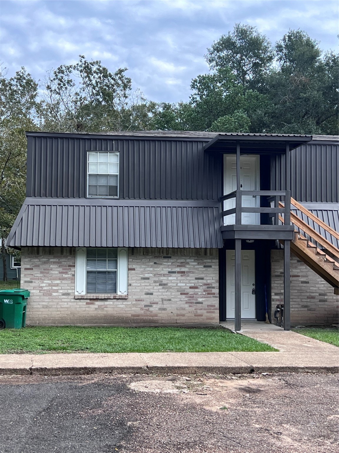 503 Park Lane, Unit 1 Cleveland, TX 77327 - Photo 1 of 9 a view of a brick house with a yard and a large wooden fence