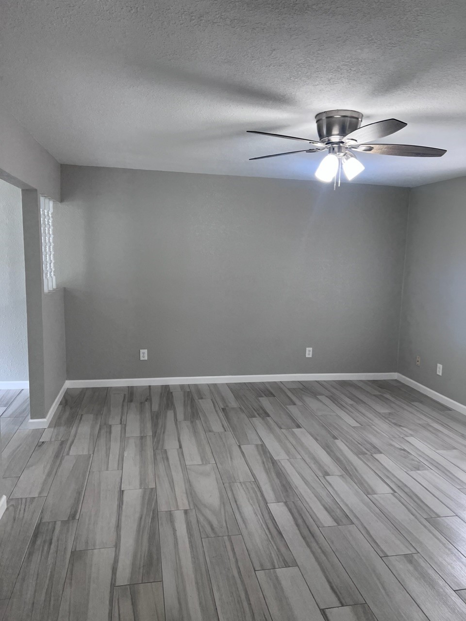 503 Park Lane, Unit 1 Cleveland, TX 77327 - Photo 2 of 9 a view of an empty room with wooden floor