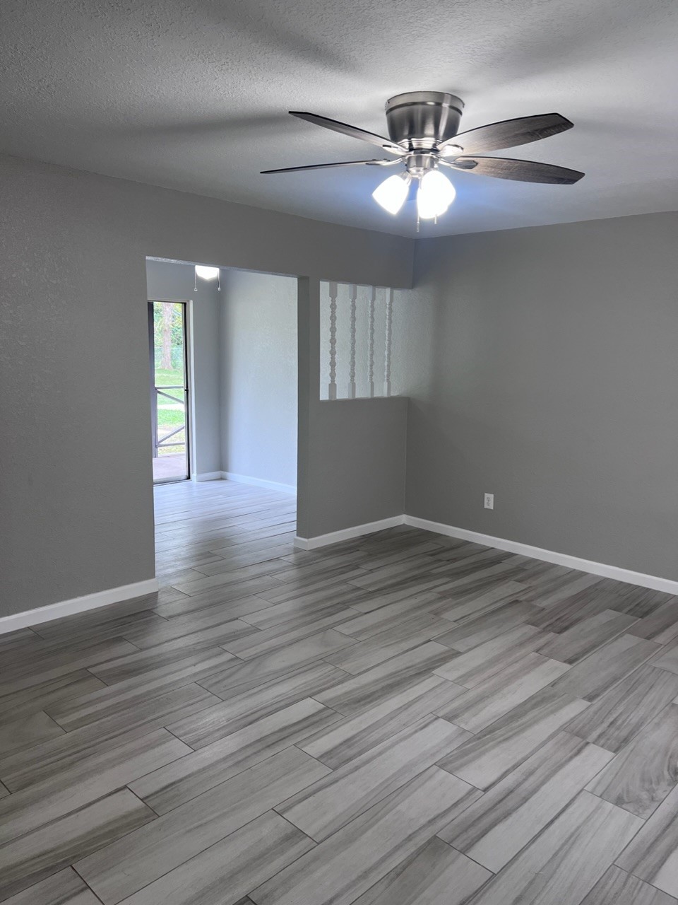 503 Park Lane, Unit 1 Cleveland, TX 77327 - Photo 3 of 9 a view of an empty room with wooden floor
