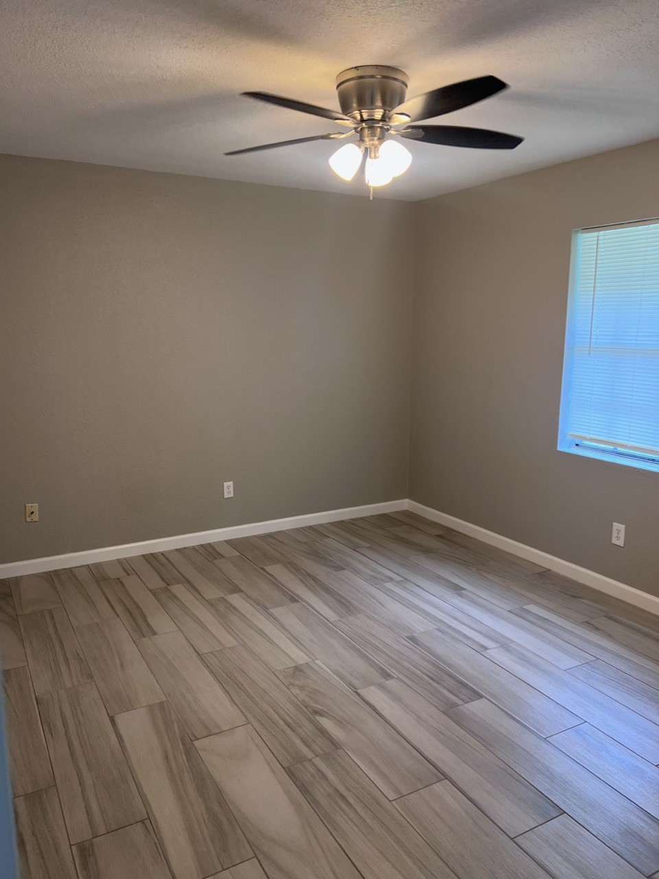 503 Park Lane, Unit 1 Cleveland, TX 77327 - Photo 8 of 9 a view of an empty room with wooden floor