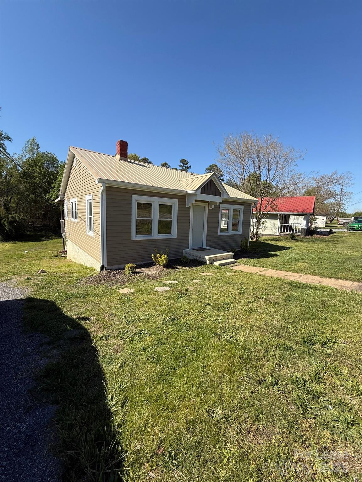 a front view of a house with a garden