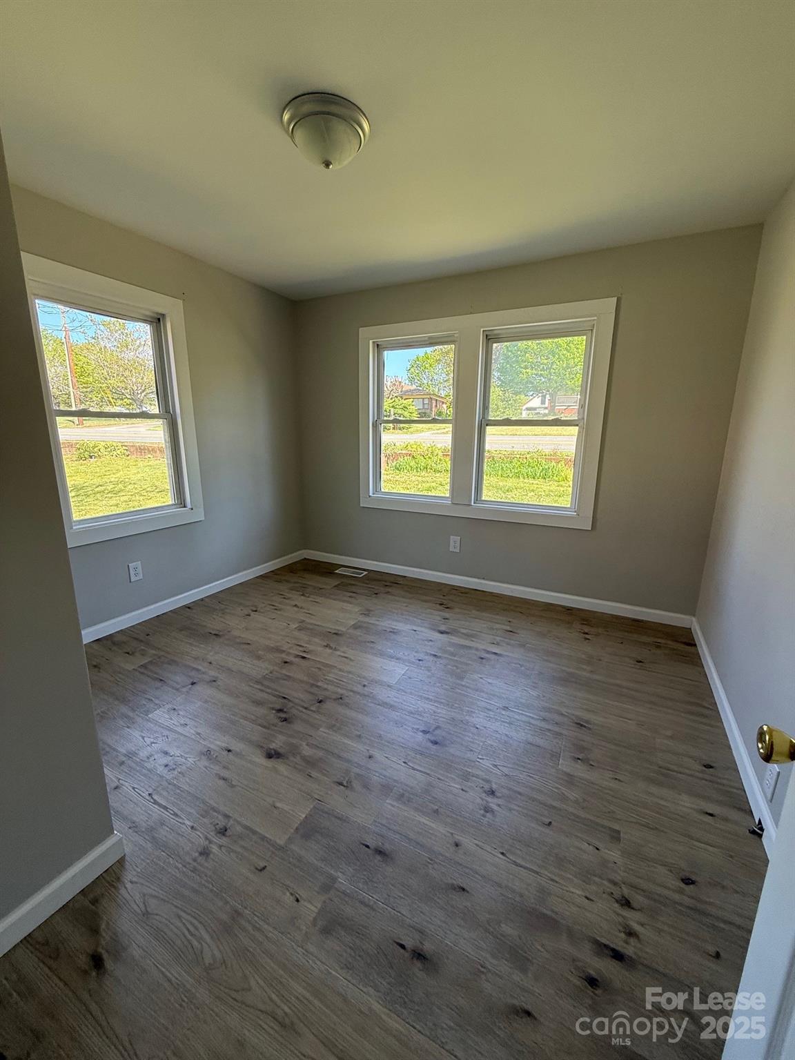2140 Enon Road Morganton, NC 28655 - Photo 5 of 13 a view of an empty room with wooden floor and a window