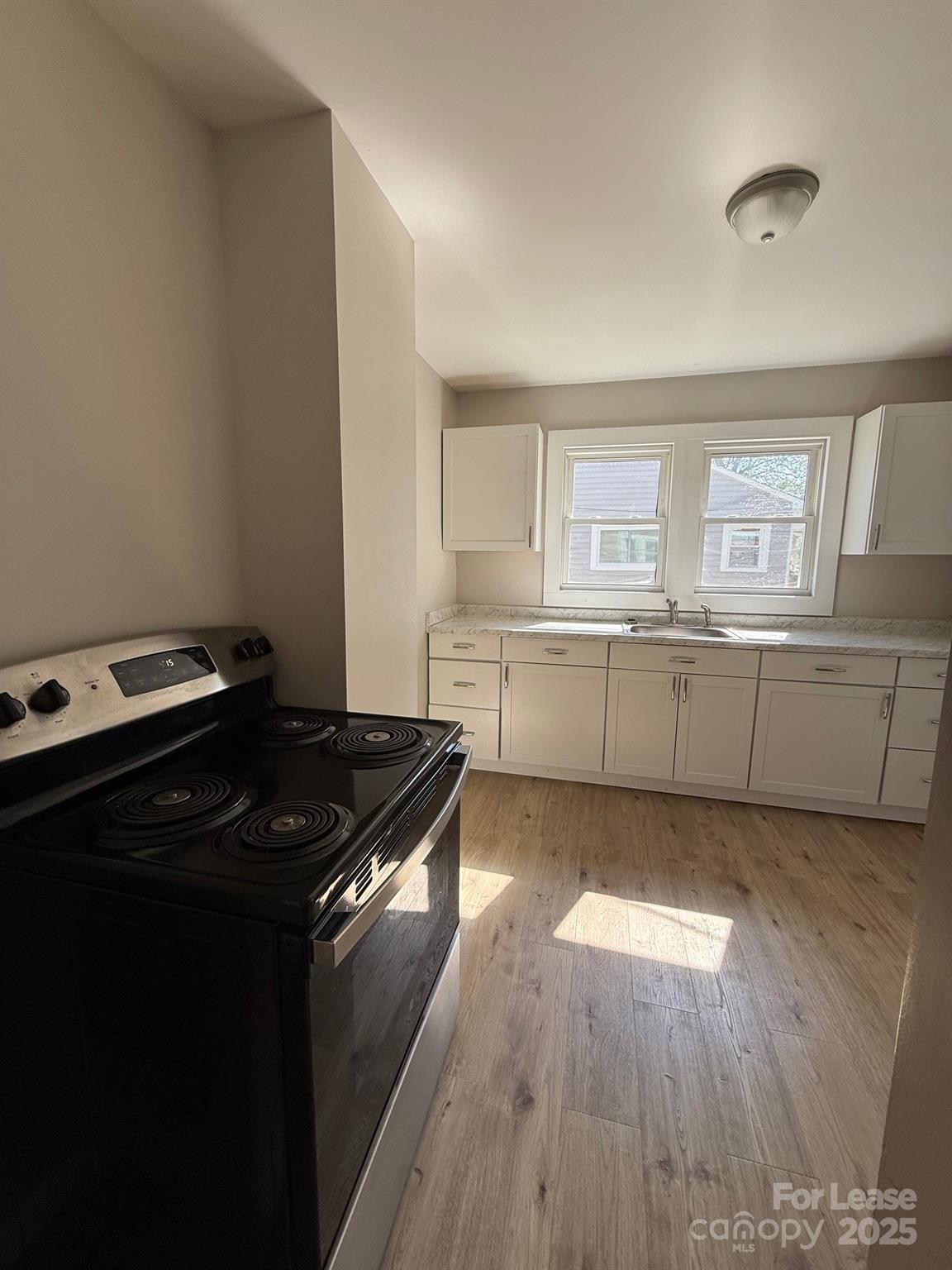 2140 Enon Road Morganton, NC 28655 - Photo 7 of 13 a kitchen with a stove and a refrigerator