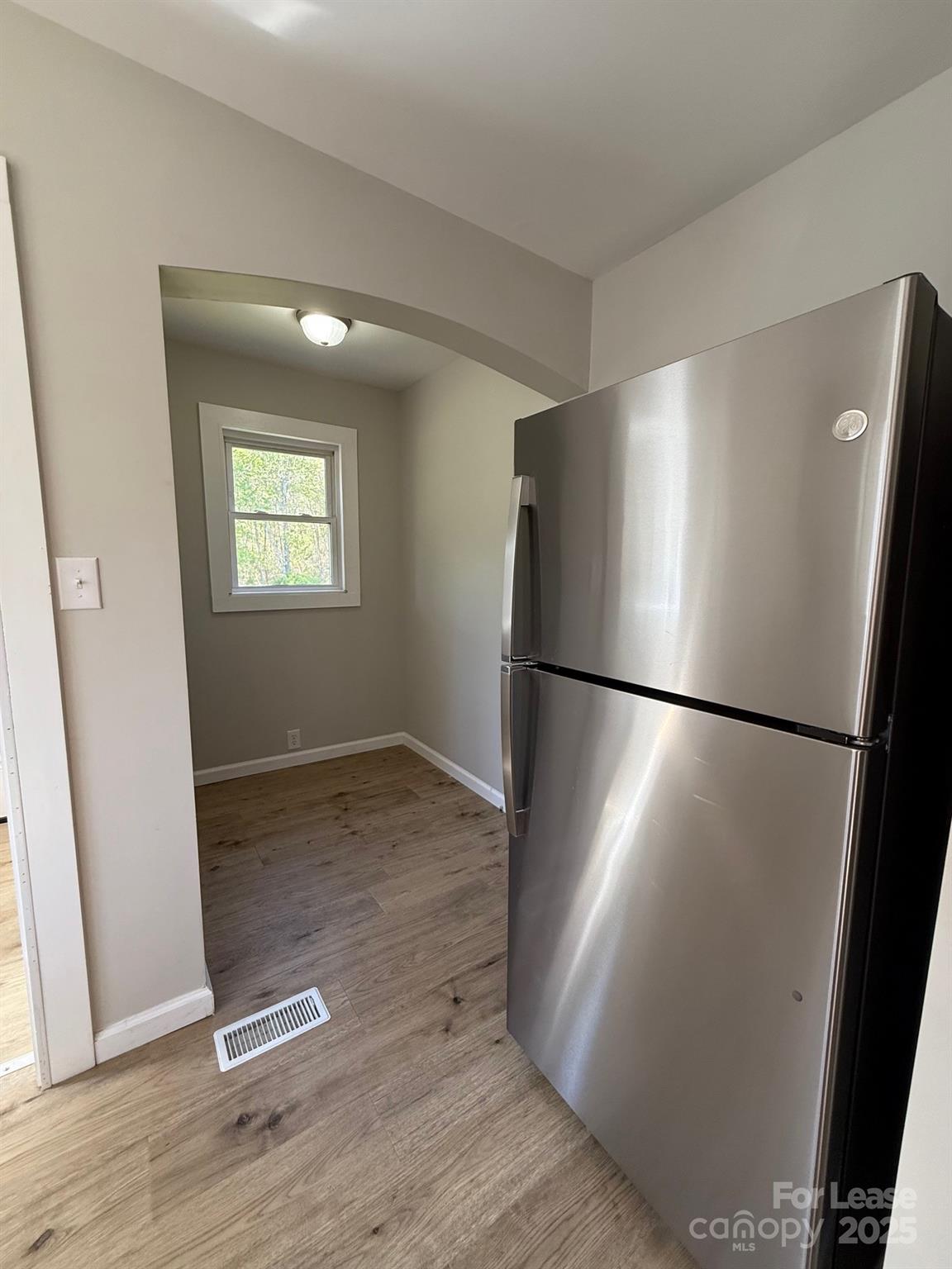 2140 Enon Road Morganton, NC 28655 - Photo 9 of 13 a view of a refrigerator in kitchen and wooden floor
