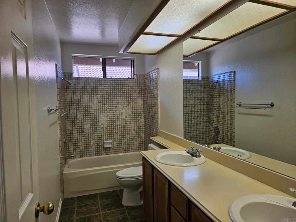 9329 Parus Point San Diego, CA 92129 - Photo 17 of 30 a bathroom with a sink toilet and shower