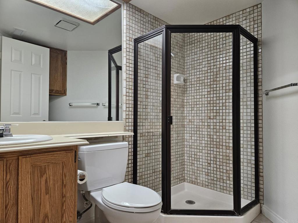 9329 Parus Point San Diego, CA 92129 - Photo 19 of 30 a bathroom with a toilet a sink and shower