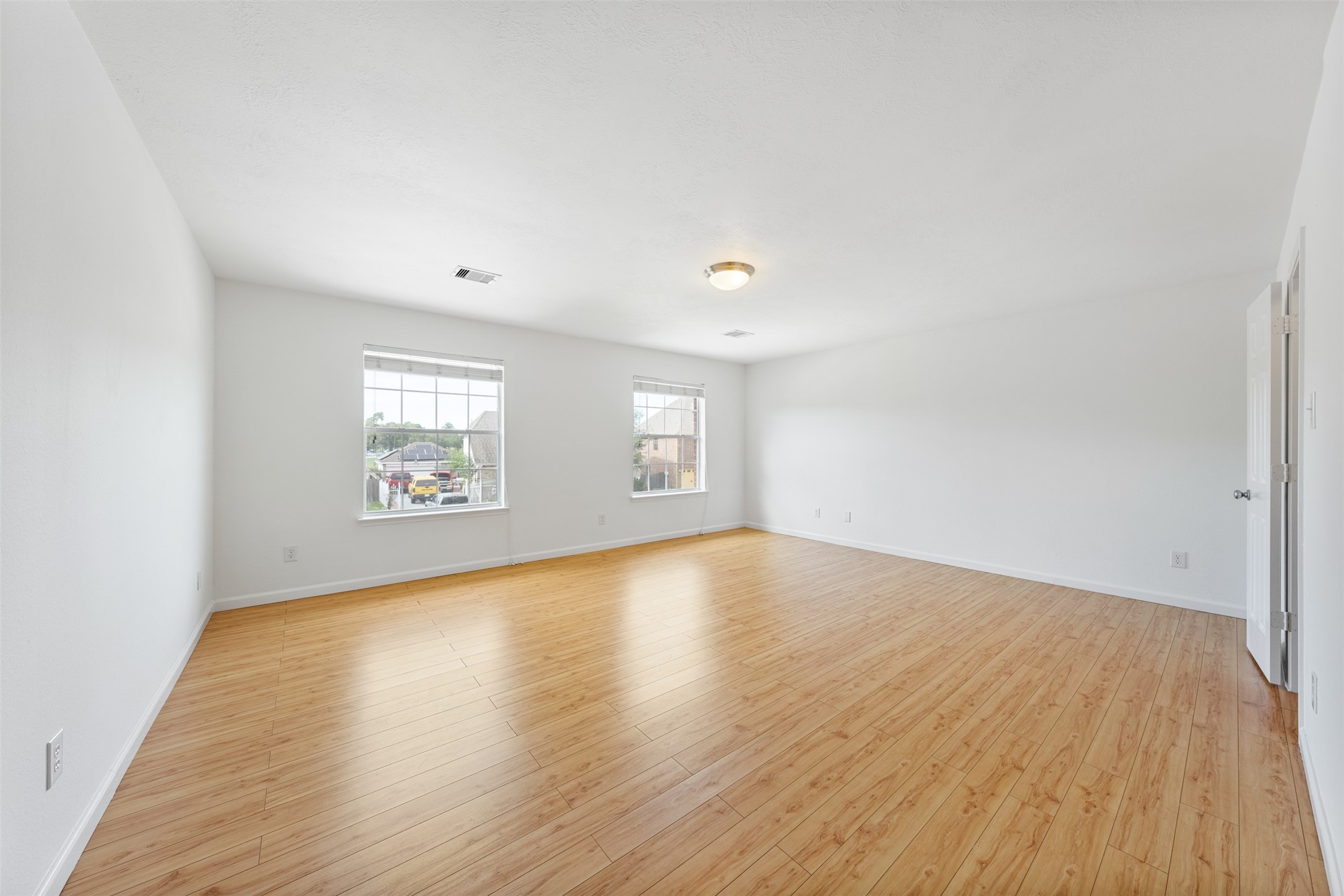 6806 Stableton Lane Houston, TX 77049 - Photo 11 of 50 an empty room with wooden floor and windows