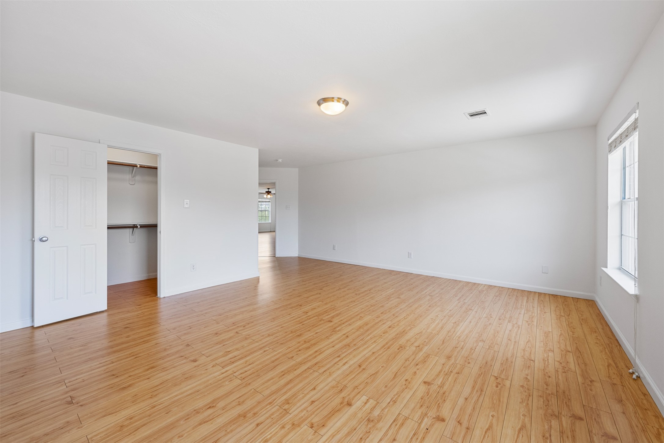 6806 Stableton Lane Houston, TX 77049 - Photo 13 of 50 an empty room with wooden floor and windows