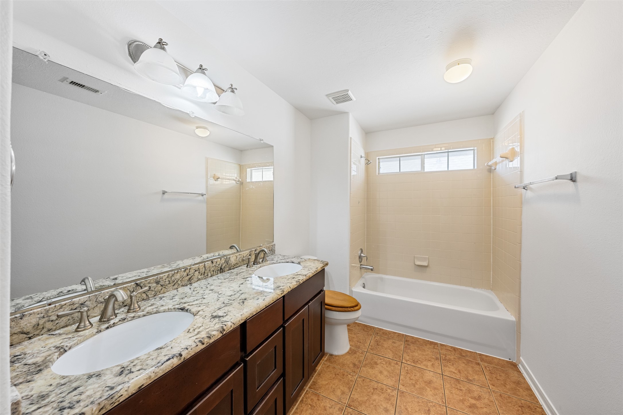 6806 Stableton Lane Houston, TX 77049 - Photo 15 of 50 a bathroom with a granite countertop sink a toilet and shower
