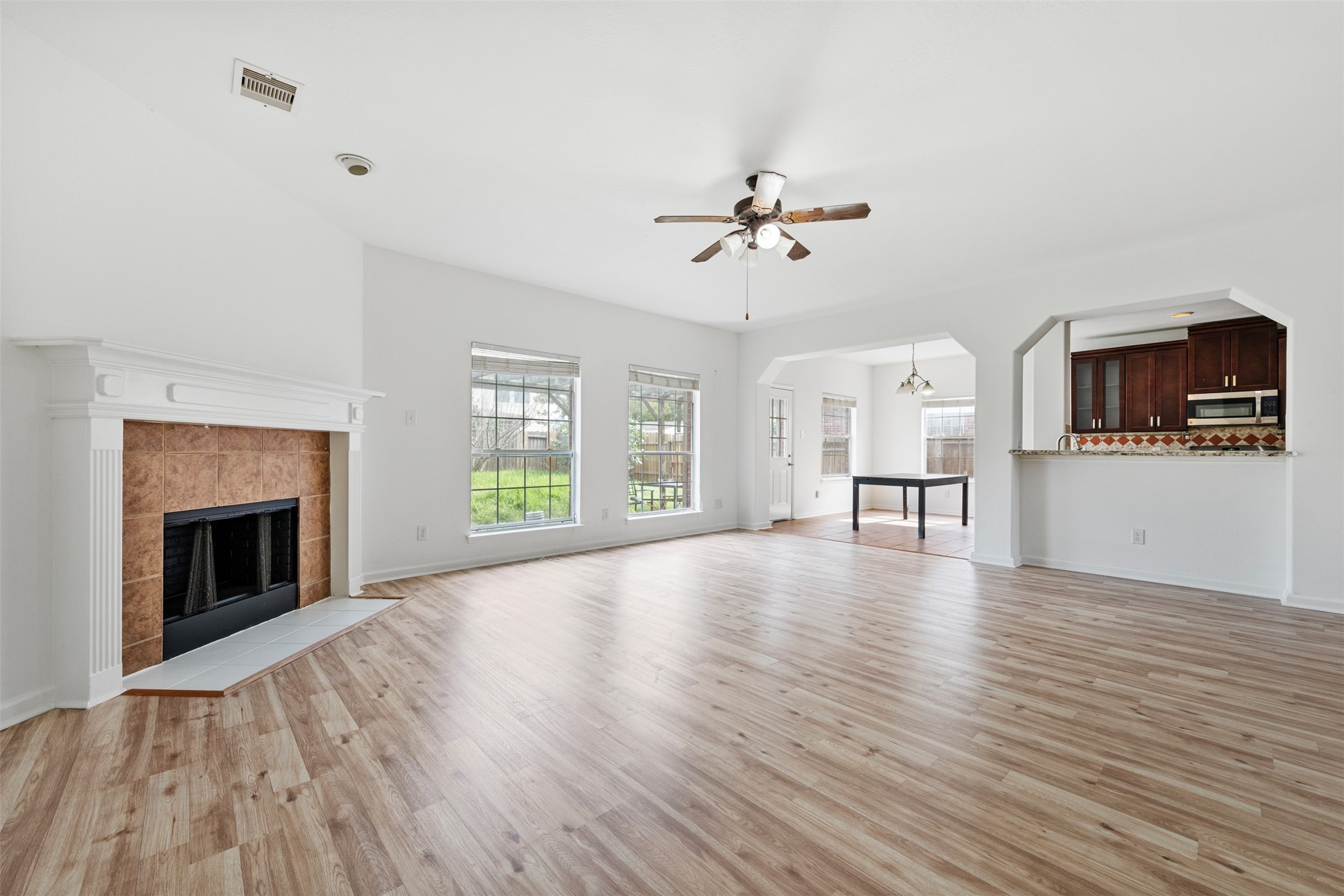 6806 Stableton Lane Houston, TX 77049 - Photo 16 of 50 a view of empty room with wooden floor and fireplace