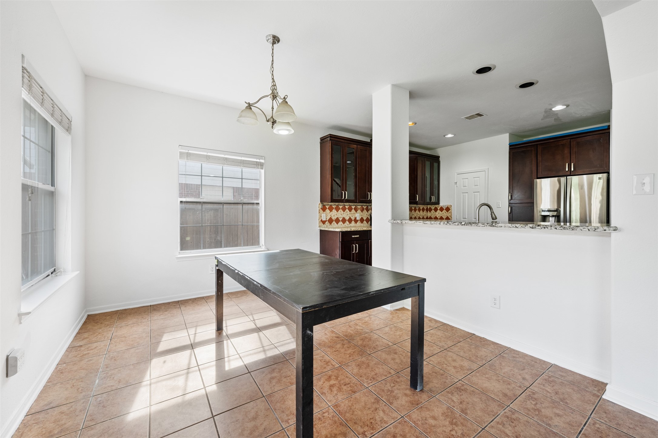 6806 Stableton Lane Houston, TX 77049 - Photo 17 of 50 a kitchen with stainless steel appliances granite countertop a refrigerator a sink dishwasher a stove and a dining table with wooden floor