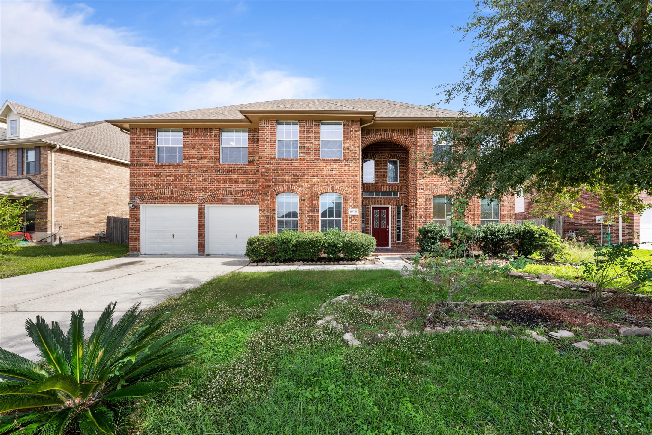 6806 Stableton Lane Houston, TX 77049 - Photo 2 of 50 a front view of a house with a yard and garage