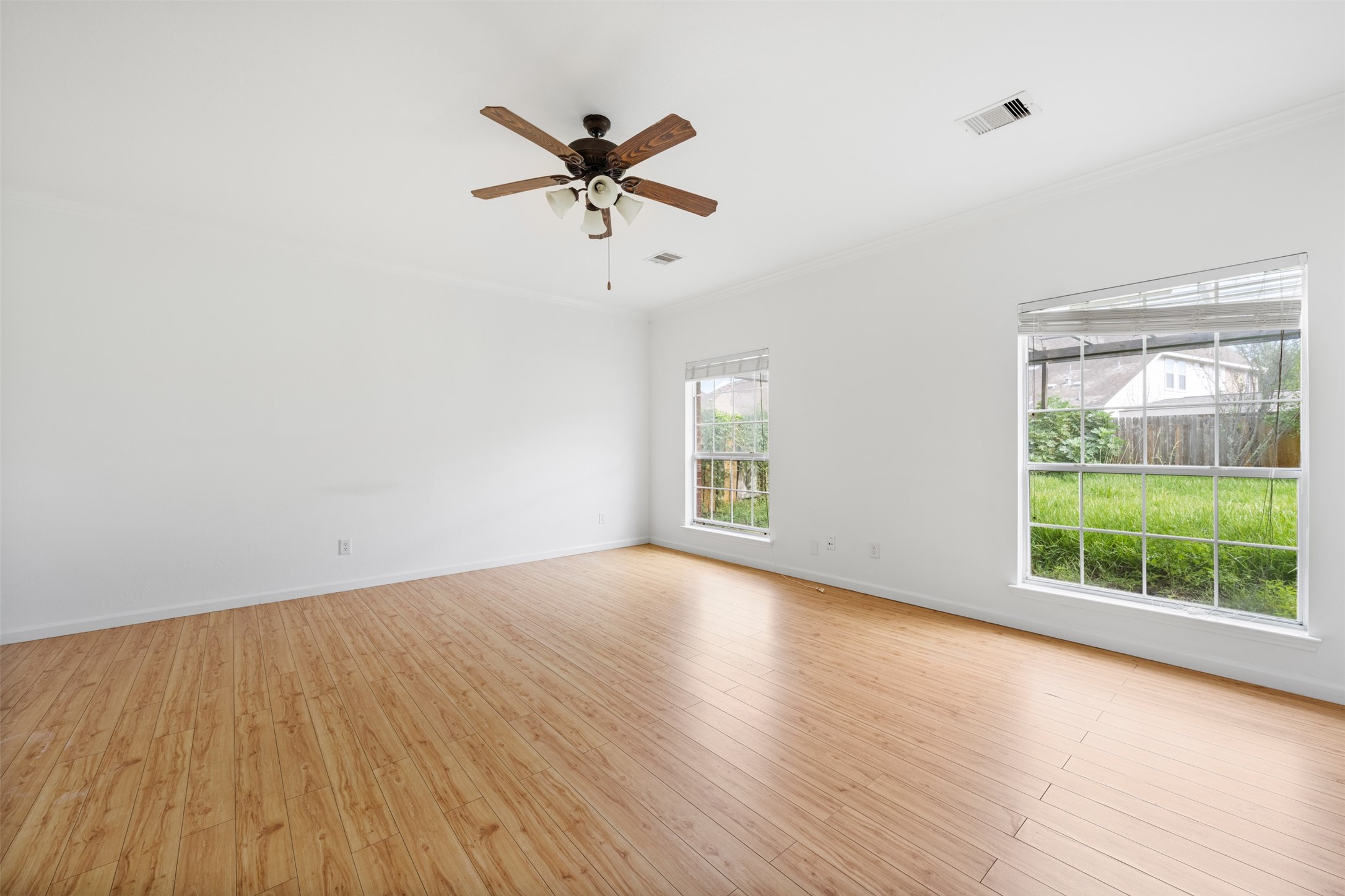 6806 Stableton Lane Houston, TX 77049 - Photo 21 of 50 an empty room with wooden floor fan and windows