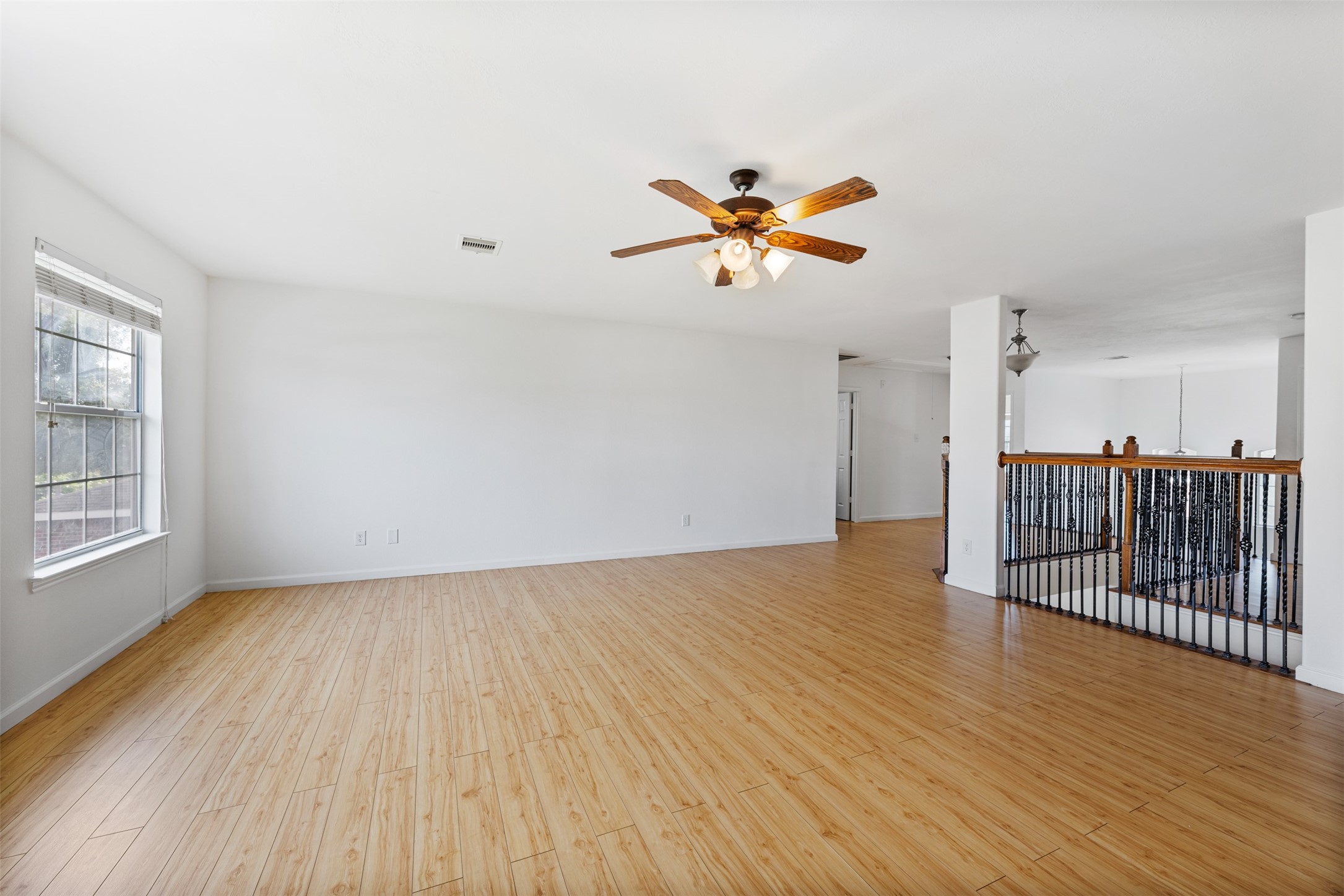 6806 Stableton Lane Houston, TX 77049 - Photo 29 of 50 an empty room with wooden floor and a ceiling fan