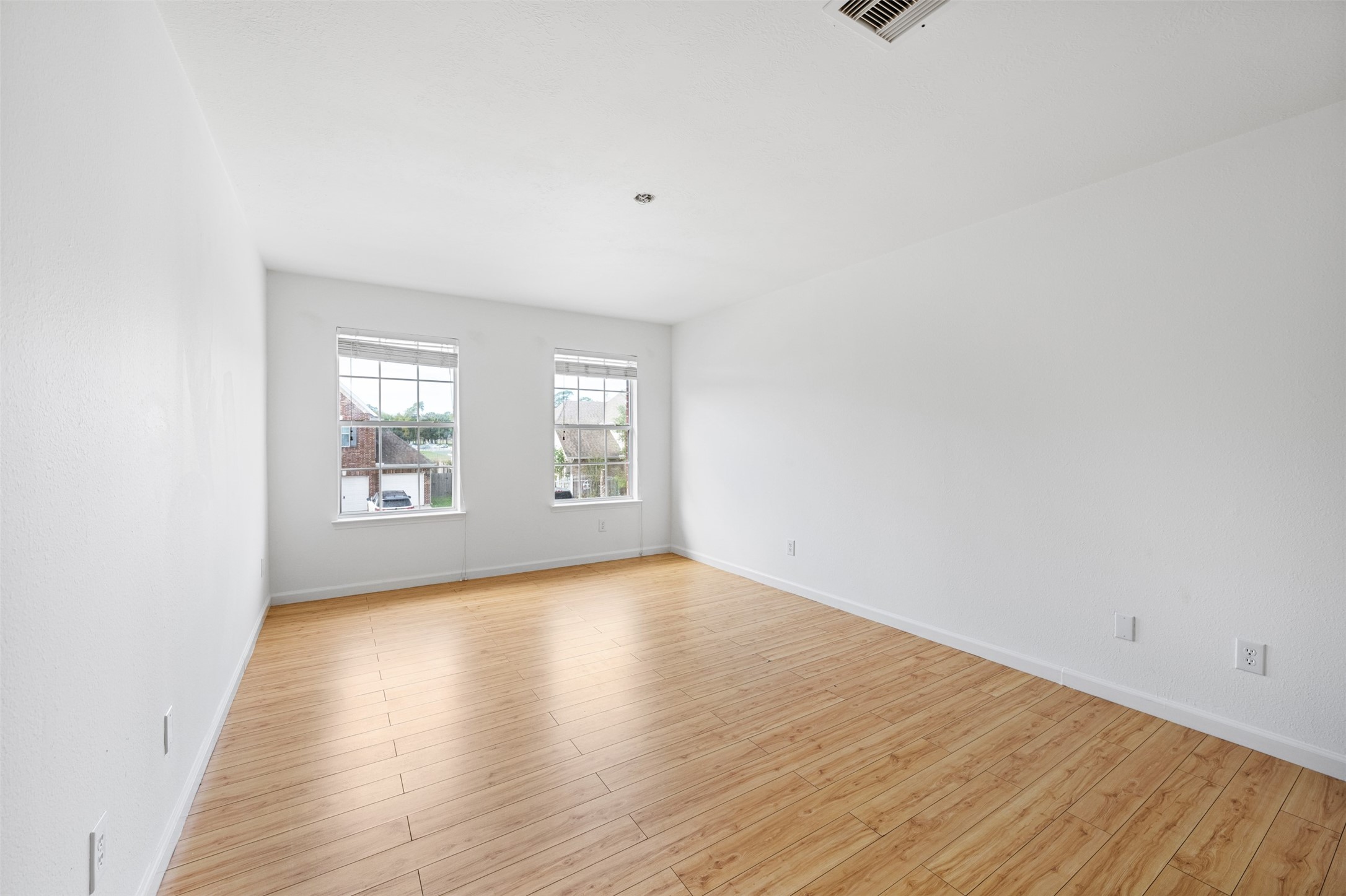 6806 Stableton Lane Houston, TX 77049 - Photo 35 of 50 a view of an empty room with wooden floor and a window