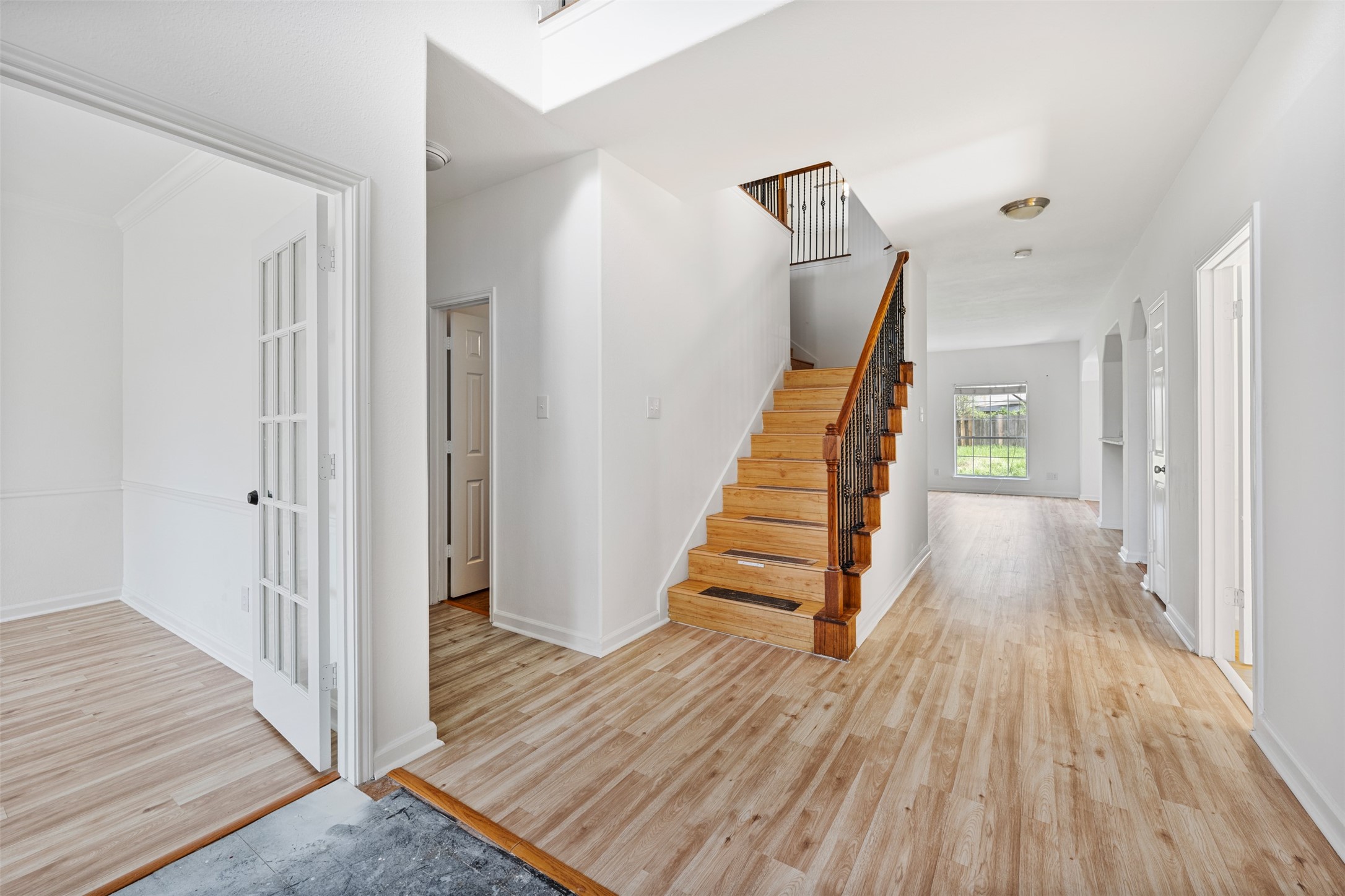 6806 Stableton Lane Houston, TX 77049 - Photo 37 of 50 a view of a hallway with wooden floor and stairs