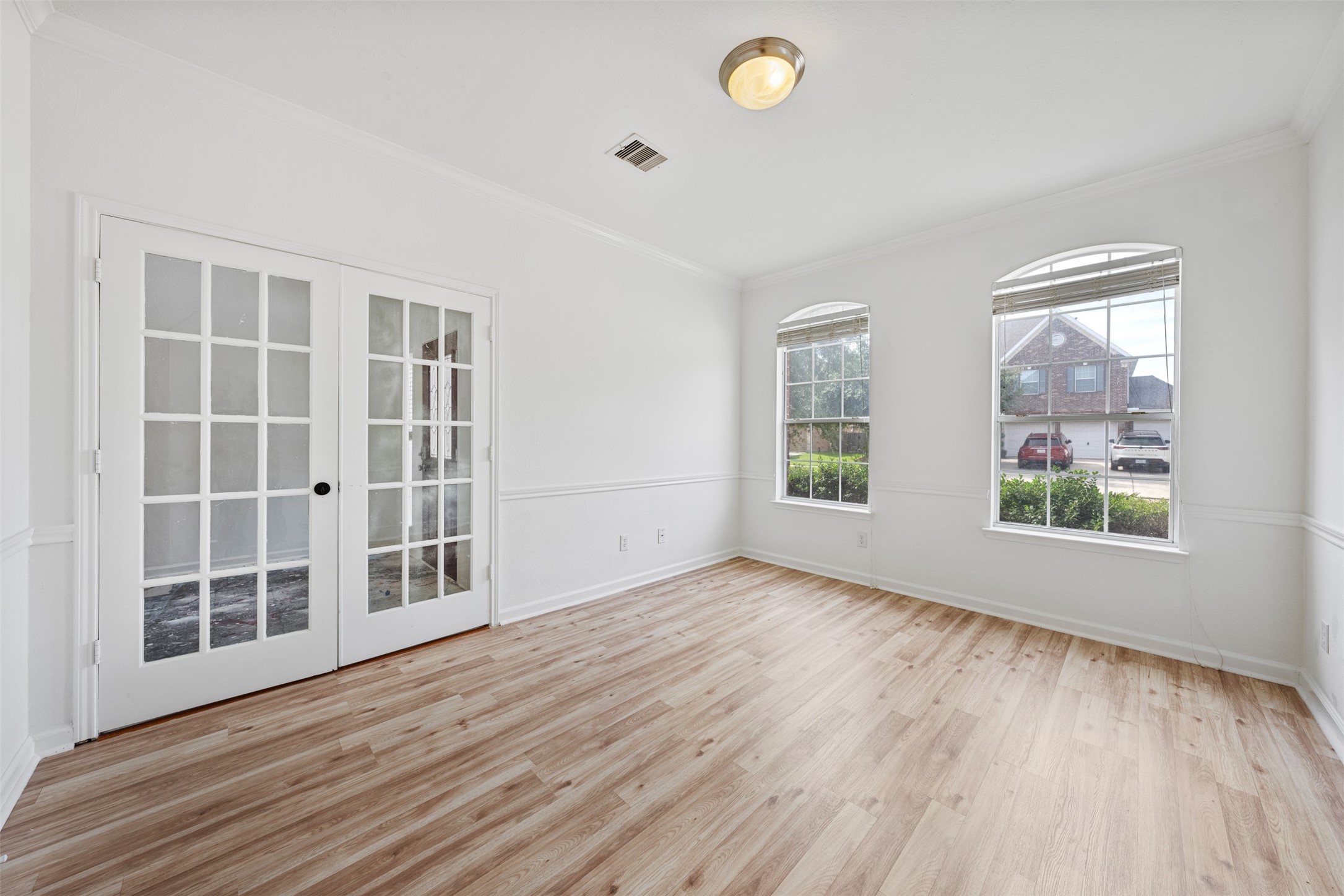 6806 Stableton Lane Houston, TX 77049 - Photo 39 of 50 an empty room with wooden floor and windows