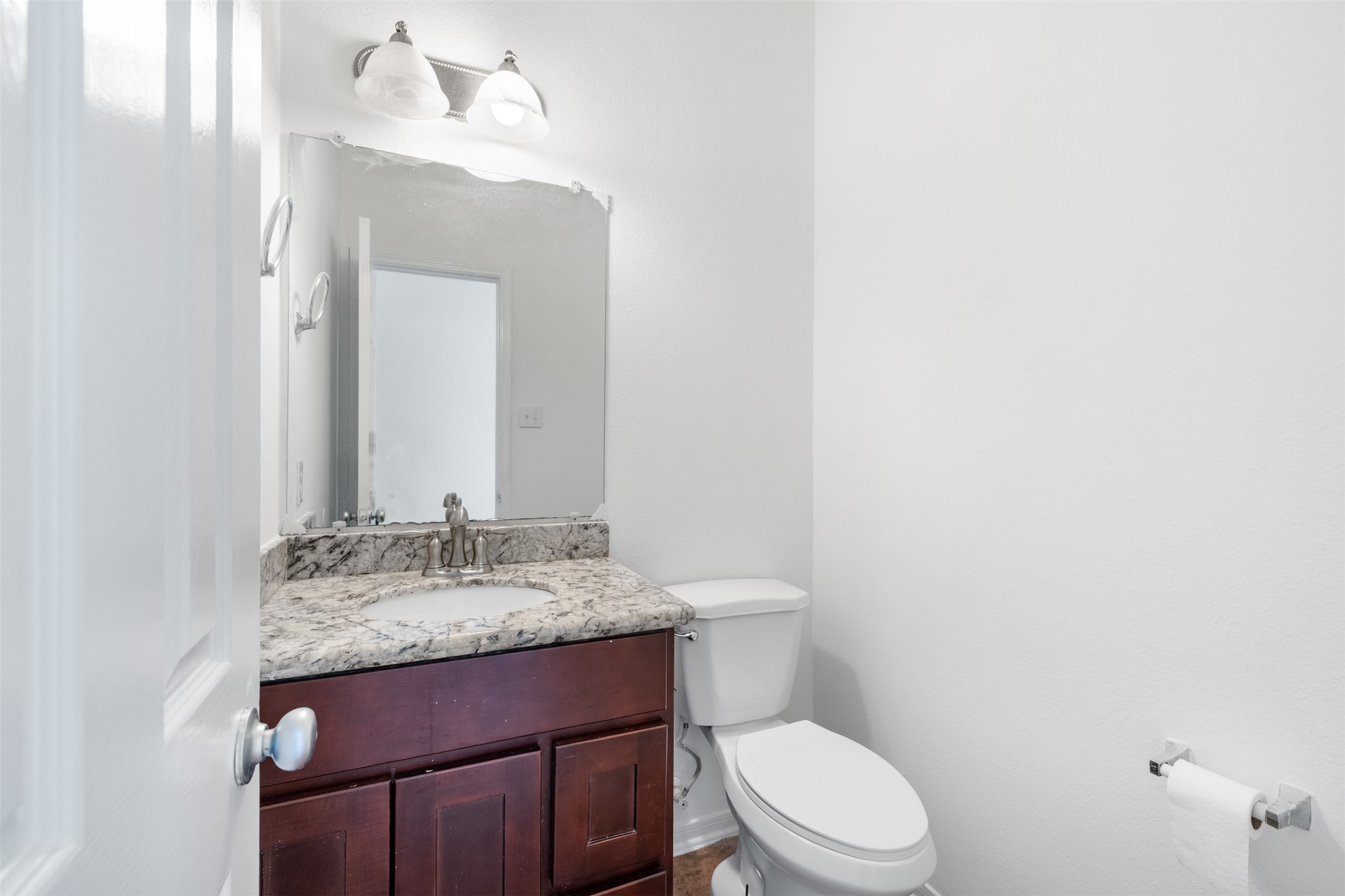 6806 Stableton Lane Houston, TX 77049 - Photo 41 of 50 a bathroom with a granite countertop toilet sink and mirror