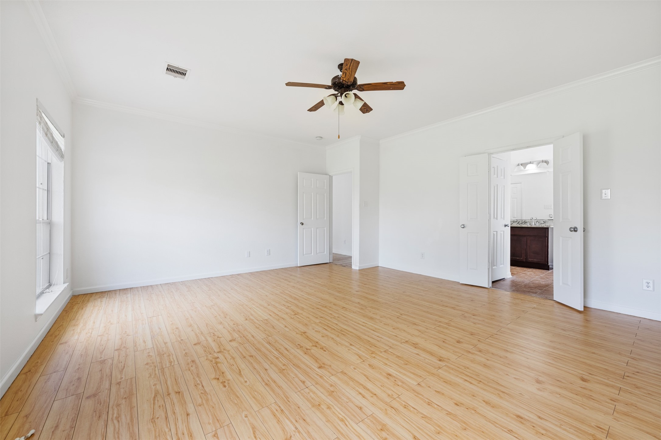 6806 Stableton Lane Houston, TX 77049 - Photo 48 of 50 a view of empty room with wooden floor and ceiling fan